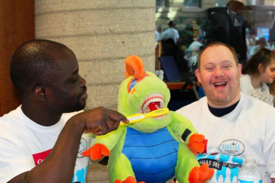 Two participants at the annual Sharing Smiles Day sit together at a table.