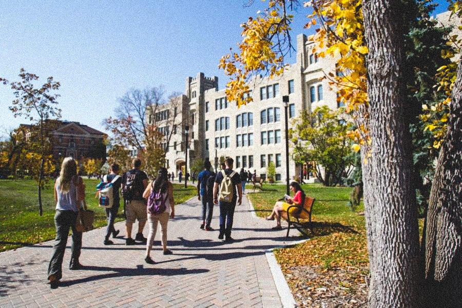 Students walking outside during summer on UM's Fort Garry campus headed towards the Buller building.